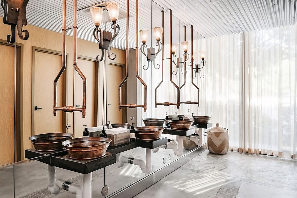 Indulge in a statement washroom with artisan basins and sunlight