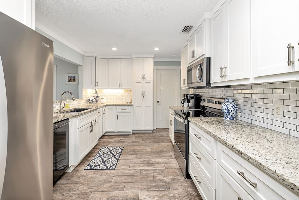 Full Kitchen – Sleek, Spacious & Ready for Crab Legs - This updated kitchen in your St. Simons Island vacation rental features stainless appliances, granite countertops, and plenty of space to prep a feast from the Village Market or fire up leftovers from Southern Soul BBQ.