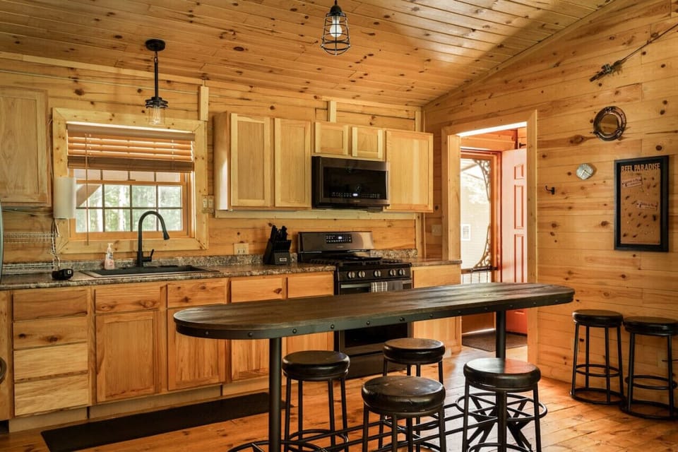 he black appliances combined with warm wood finishes make this kitchen a cozy and stylish place to cook your favorite meals.