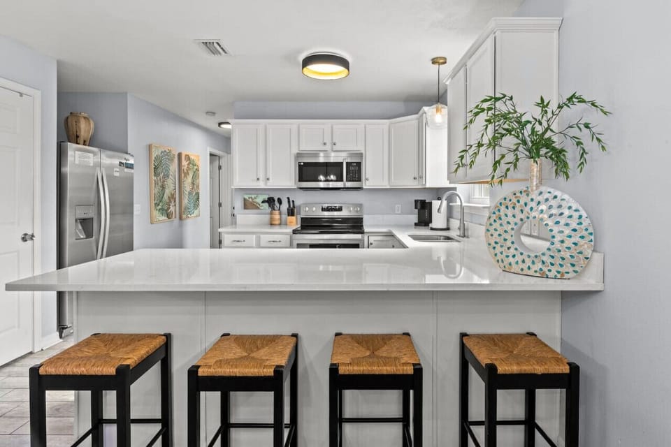 Spacious Kitchen with a Welcoming Breakfast Bar Bathed in Natural Light