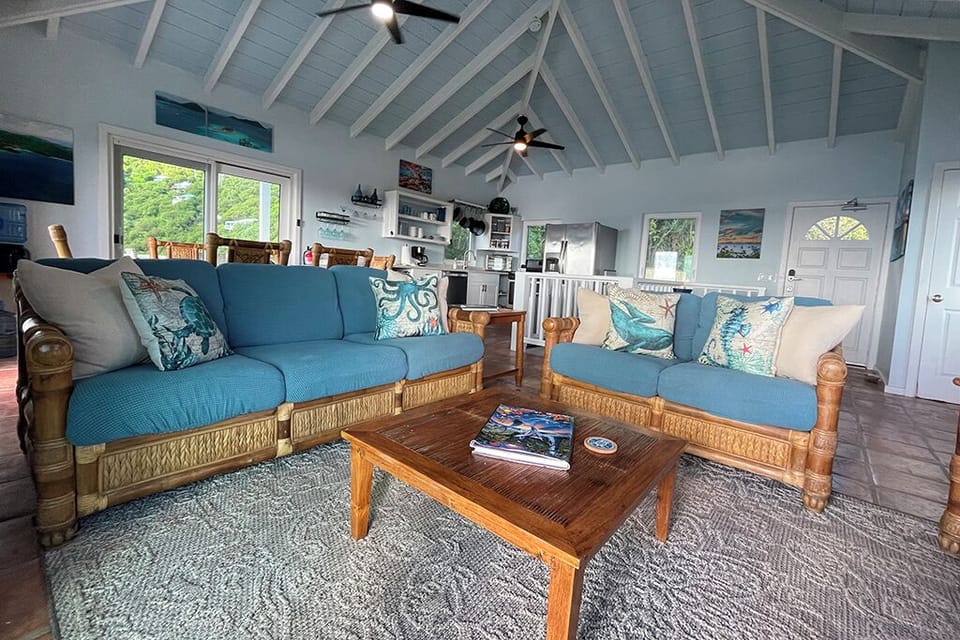 Open concept living area with West Indies style vaulted ceiling