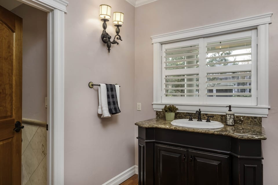 A large powder room with dedicated water closet in main floor. 
