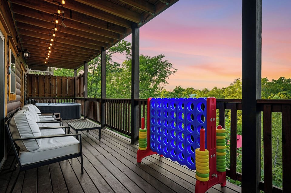 Unwind on this spacious deck featuring outdoor games and a hot tub, where sunset views create magical evenings.