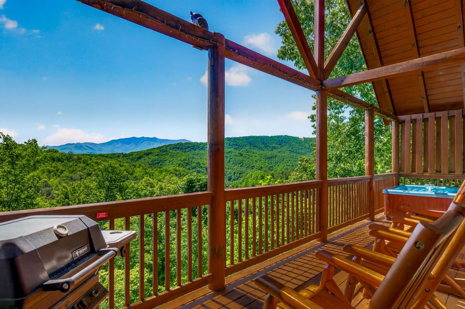 Breathtaking mountain views stretch across the horizon from your private deck, where you'll find a hot tub, BBQ grill, and cozy seating for relaxing mornings and evenings.