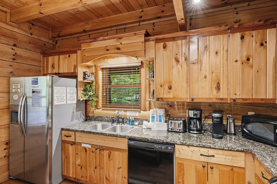 Step into your fully-equipped mountain kitchen, where rustic knotty pine cabinets and modern appliances blend perfectly for your home-away-from-home retreat.