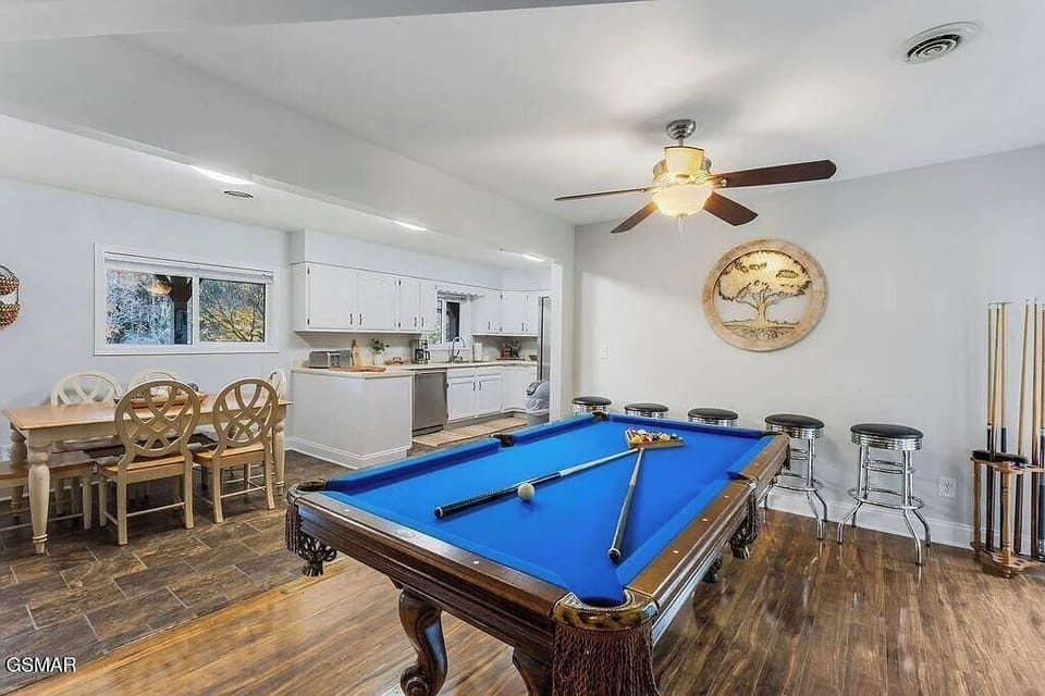 Your perfect entertainment space awaits with a regulation pool table, stylish bar seating, and open kitchen—ideal for memorable gatherings.