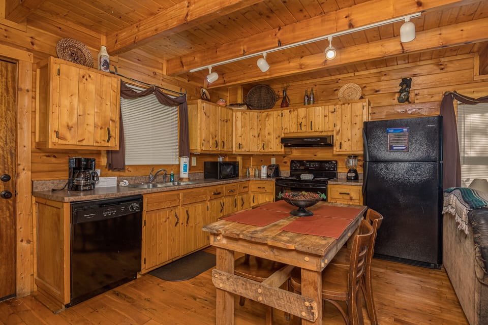 Full kitchen with dining table and chairs