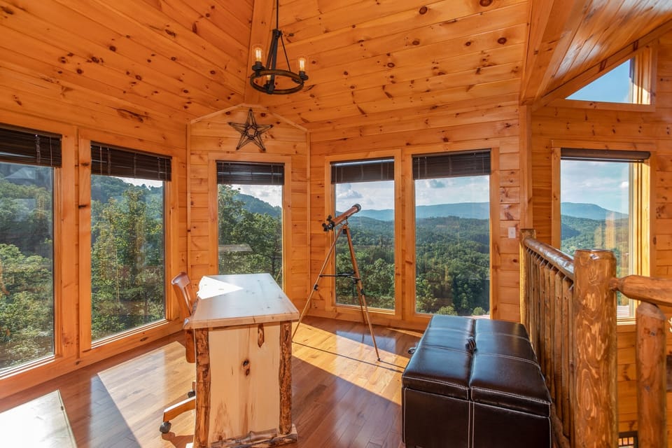 Loft space with a desk and telescope