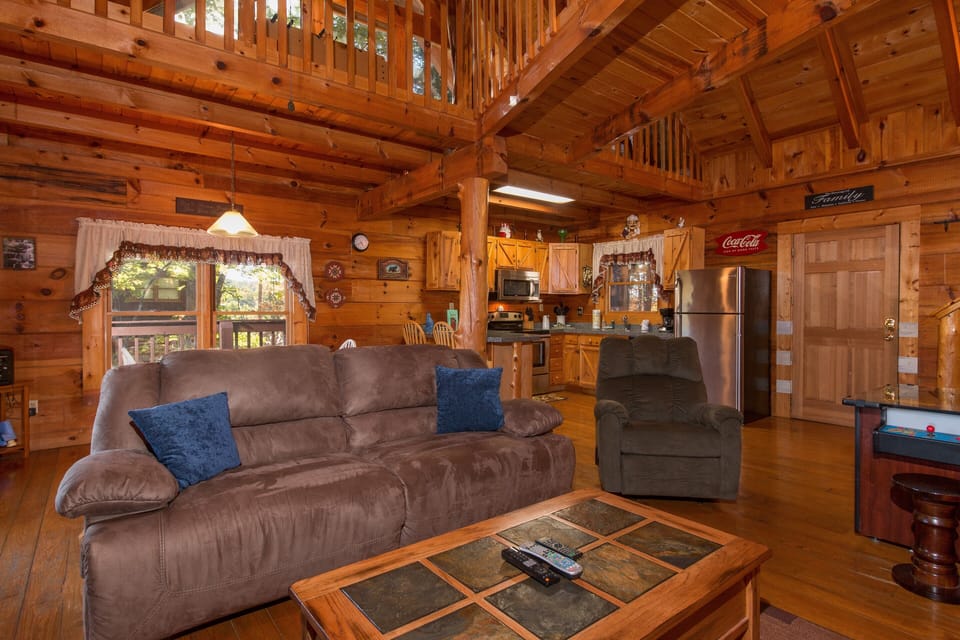 Sofa and chair in the living room at Hawk's Nest, a 1 bedroom cabin rental located in Pigeon Forge