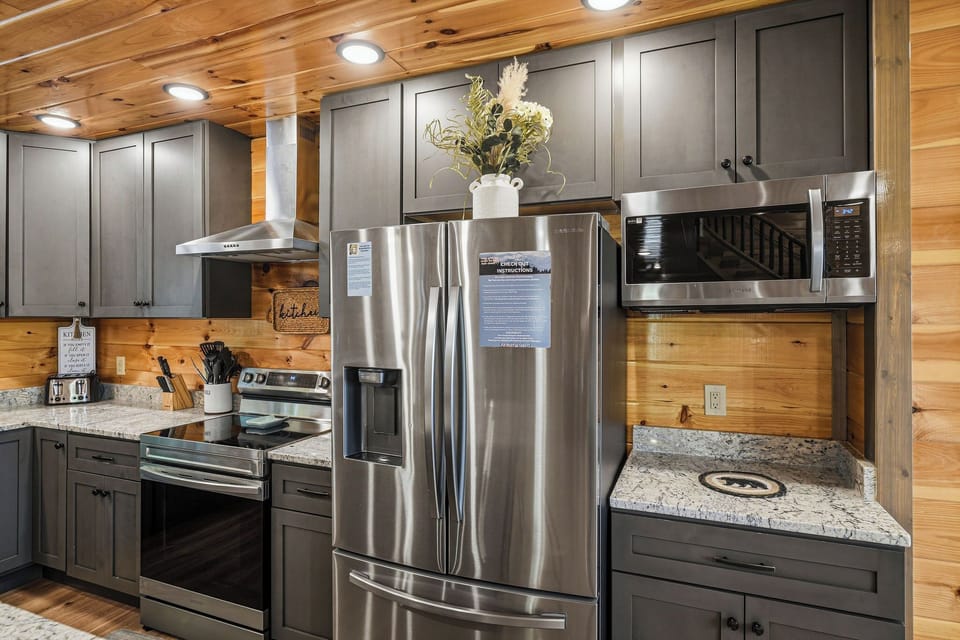 Whip up your favorite meals in this beautifully appointed kitchen with granite countertops, stainless steel appliances, and warm wood accents throughout.