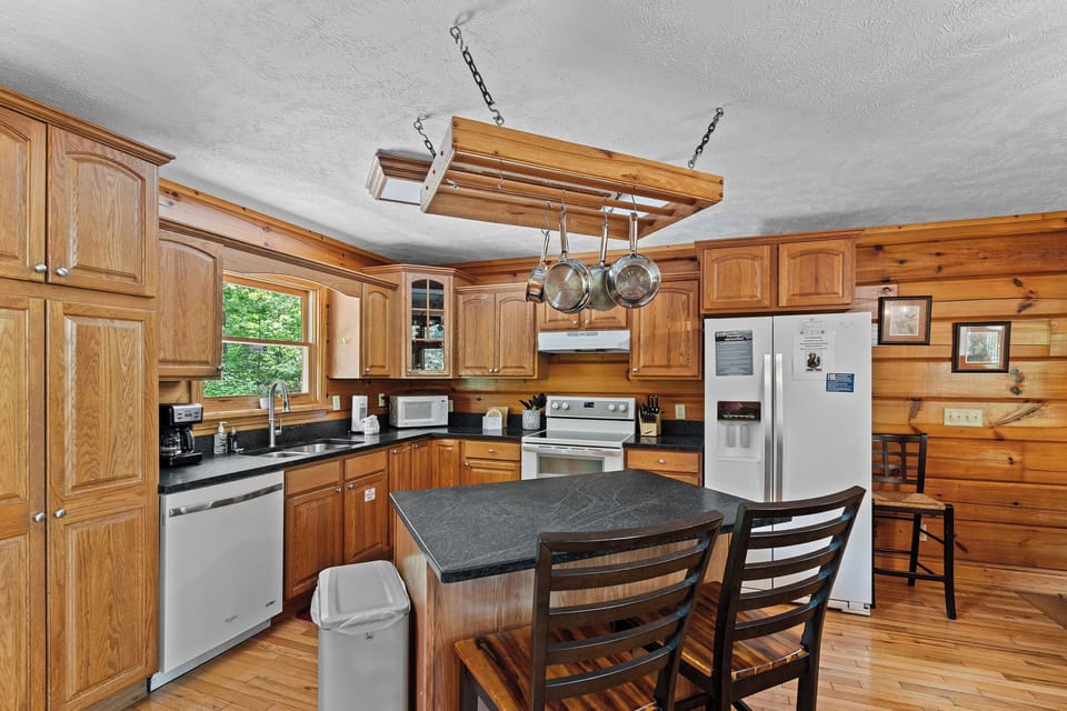 Full kitchen with island and chairs