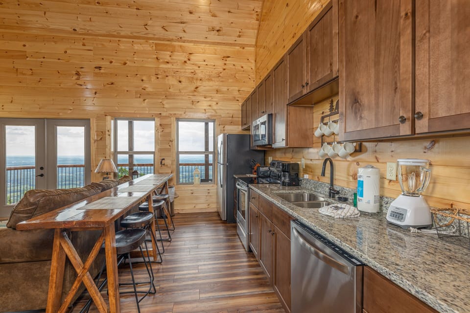 Full kitchen with long table and stools