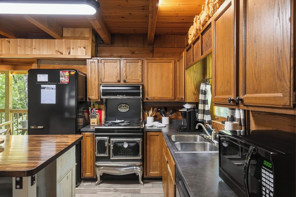 Your fully equipped rustic kitchen blends vintage charm with modern convenience, featuring warm wood cabinetry, stainless steel sinks, and everything you need to cook up memorable meals during your stay.