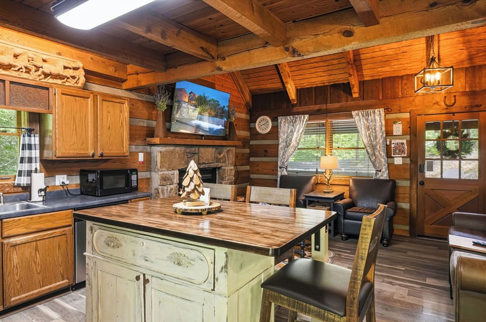 Step into your cozy log cabin retreat where rustic charm meets modern comfort. Warm wood surrounds you, from the handcrafted beams overhead to the stone fireplace inviting relaxation after your day of adventure.