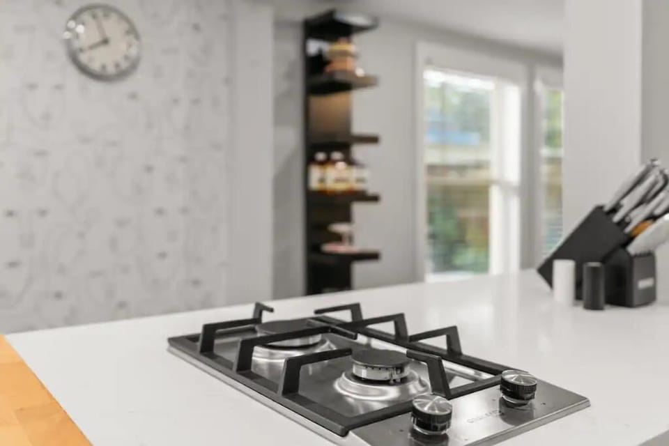 The kitchen has a double-burner gas stovetop with all essential cookware. 