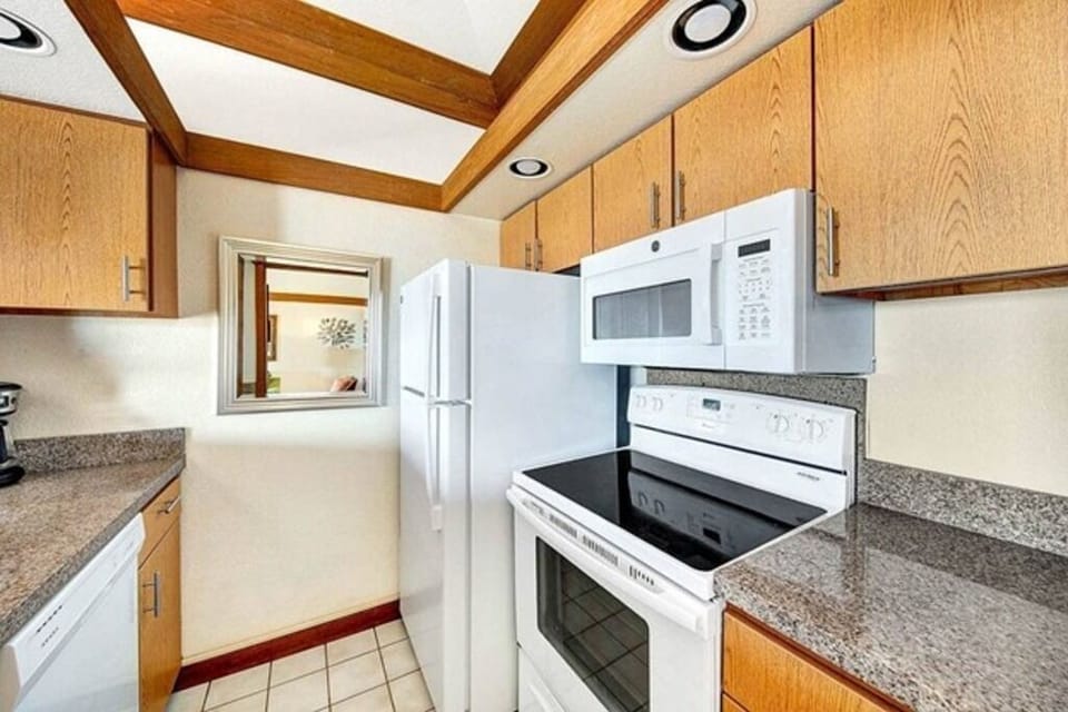 Kitchen with granite counter tops, full size stove, refridgerator and diswasher