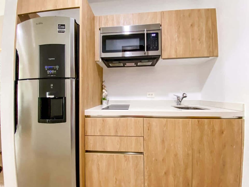 The kithchen has a large microwave, an electric stove, and all the appliances to cook your homemade recipes.