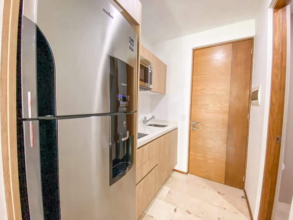 Small yet fully equipped kitchen with a large fridge & freezer