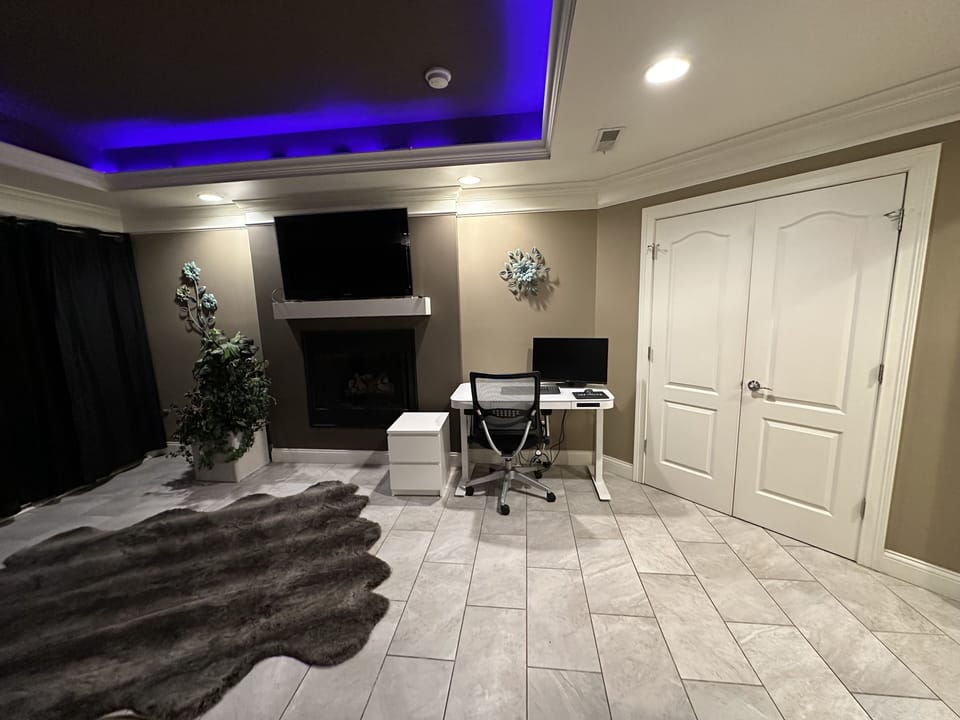 Sit/stand desk and monitor in master bedroom for remote work 