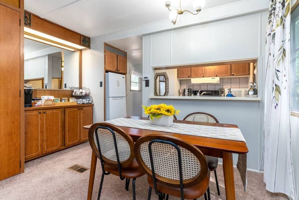 Dining Room with Table and Chairs next to Coffee Bar