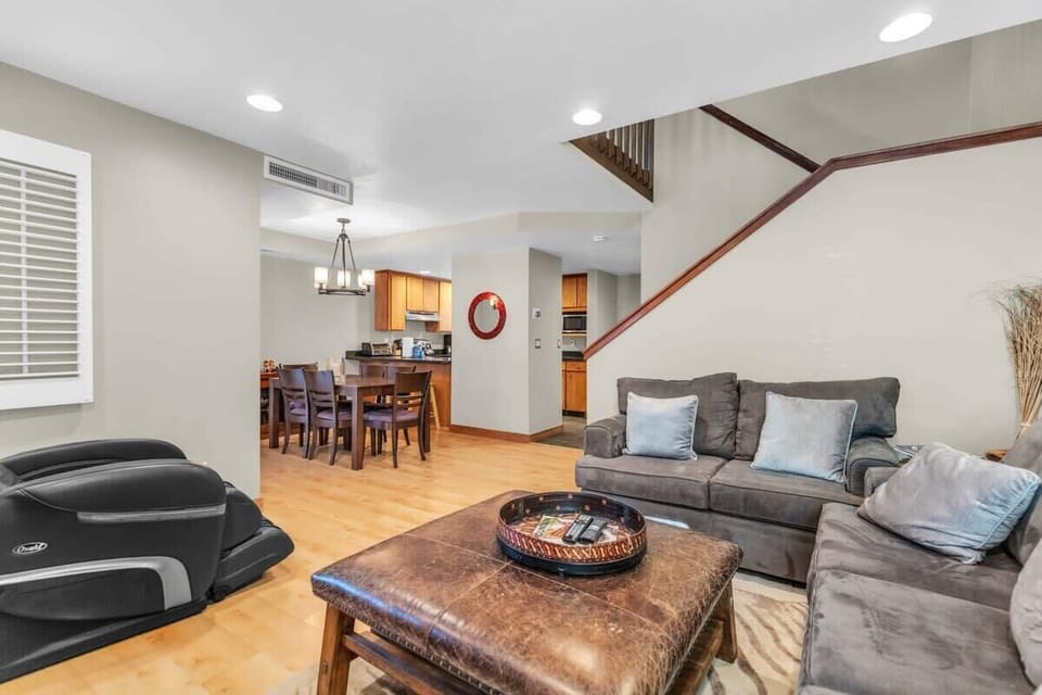 The light-filled living/dining/kitchen area boasts an open layout that blends the spaces seamlessly together.