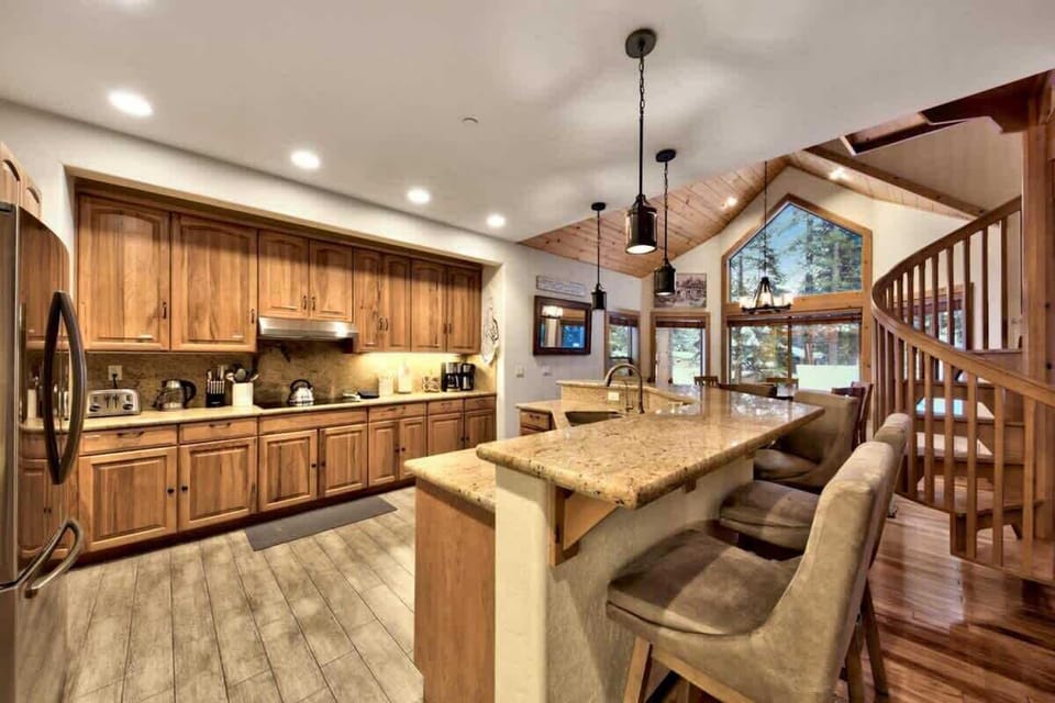 Fully equipped South Lake Tahoe vacation kitchen with electric range, stainless steel appliances, generous counter space and large island with seating for convenient group cooking and entertaining.