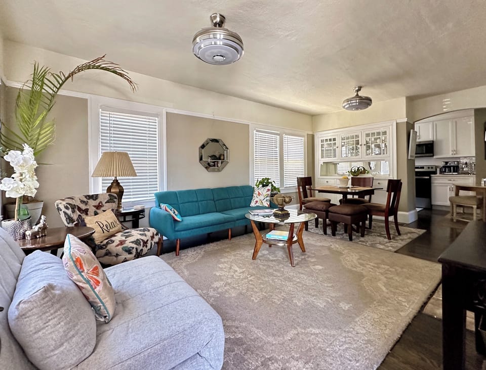 Living/diningHas 2 tw futons andelect fireplace 55” smart TV ceiling fans w Bluetooth sound