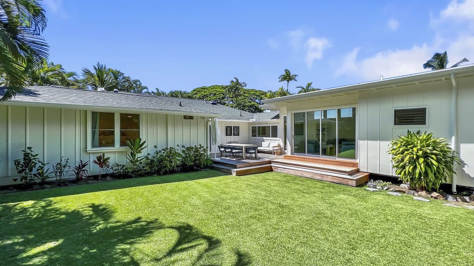 Welcome to your home away from home—framed by lush lawn, native palms, and the peaceful charm of Lanikai.