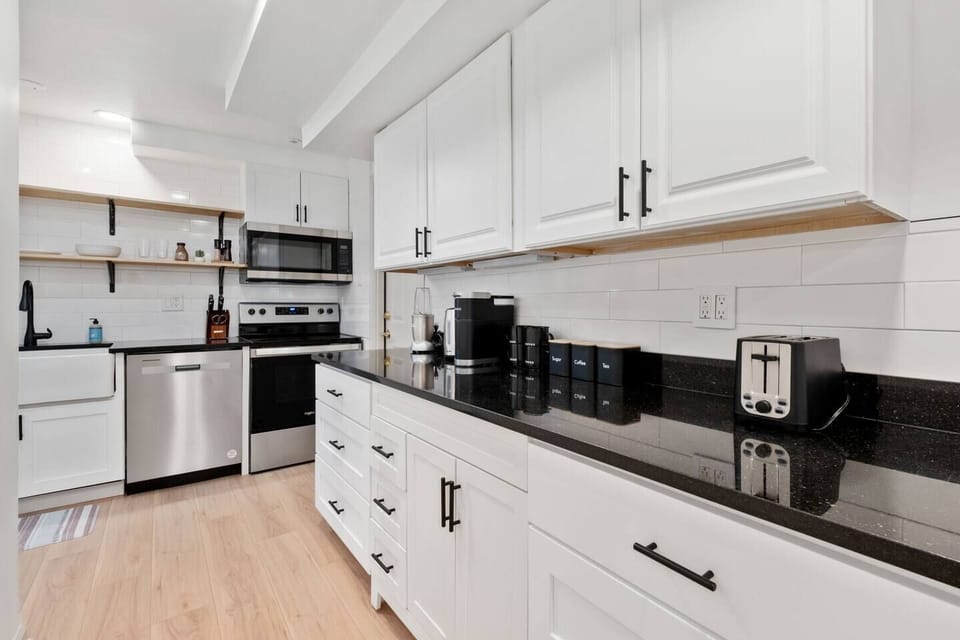 Huge kitchen counter with coffee, tea, kettle, toaster, blender, etc.