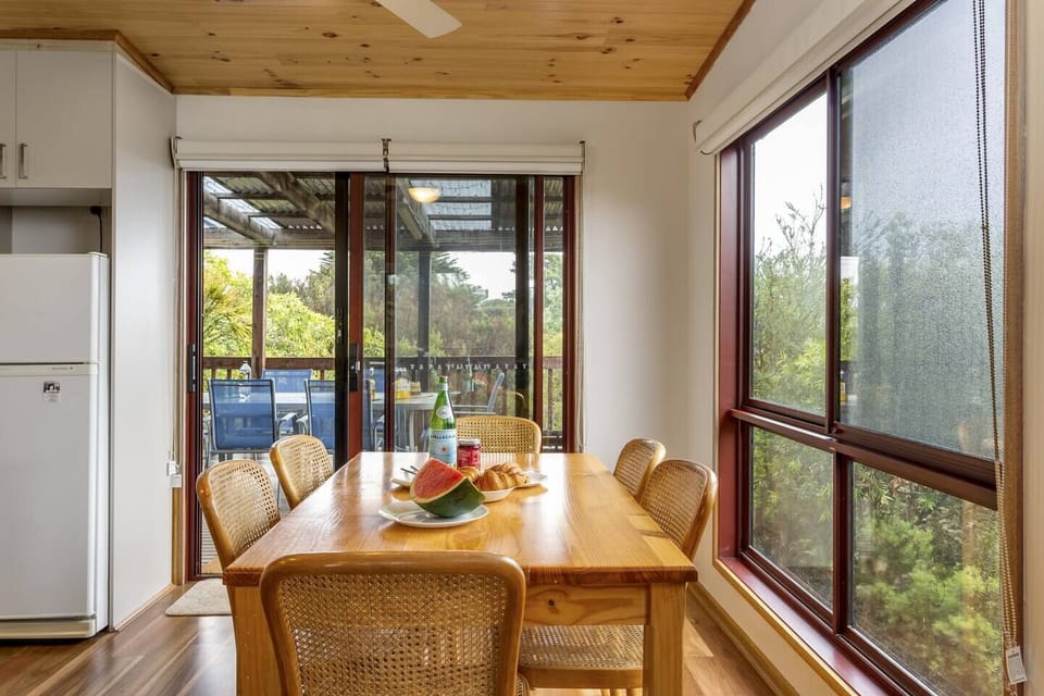 Dine in style at the timber table surrounded by chic cane chairs. 