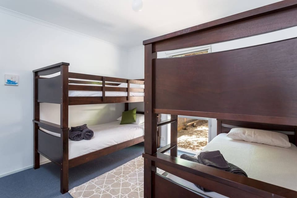 The third bedroom sleeps four adults or children across two sets of single bunks. 