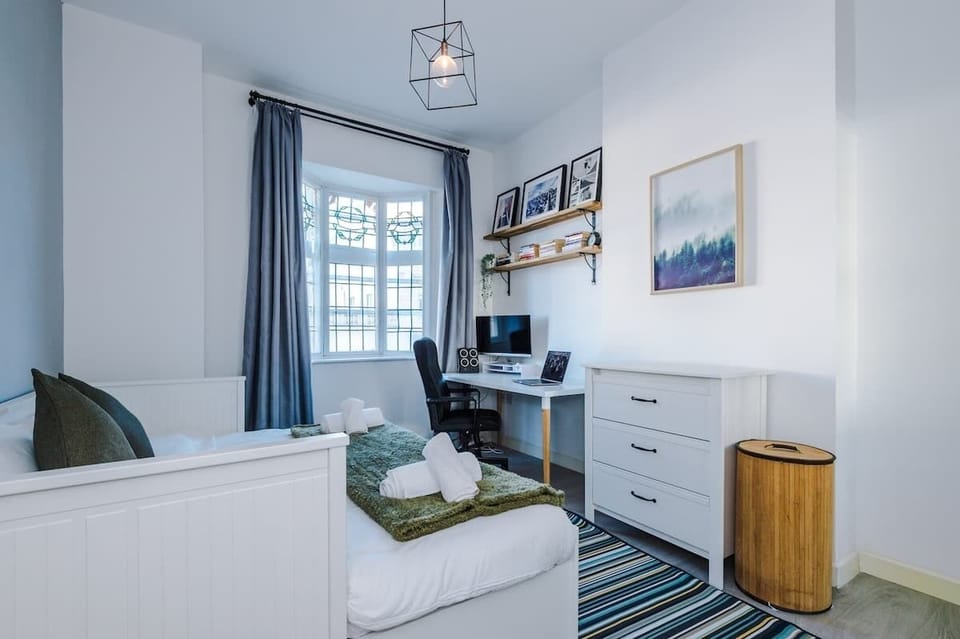 Bedroom 2 benefits from a comfortable king bed, a desk with monitor and plenty of storage.