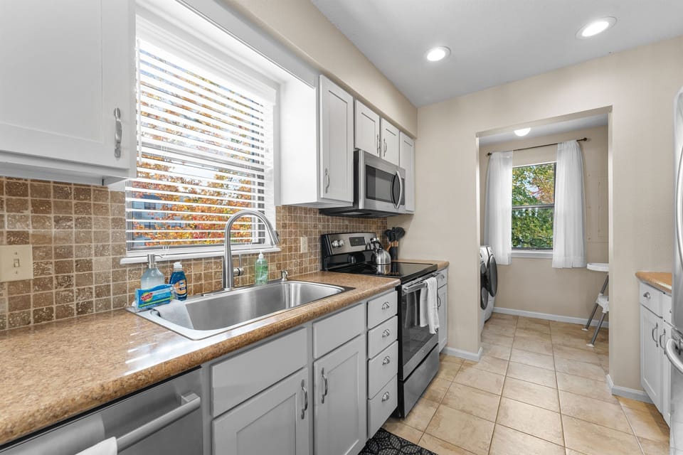 Kitchen area that leads to the washer and dryer area