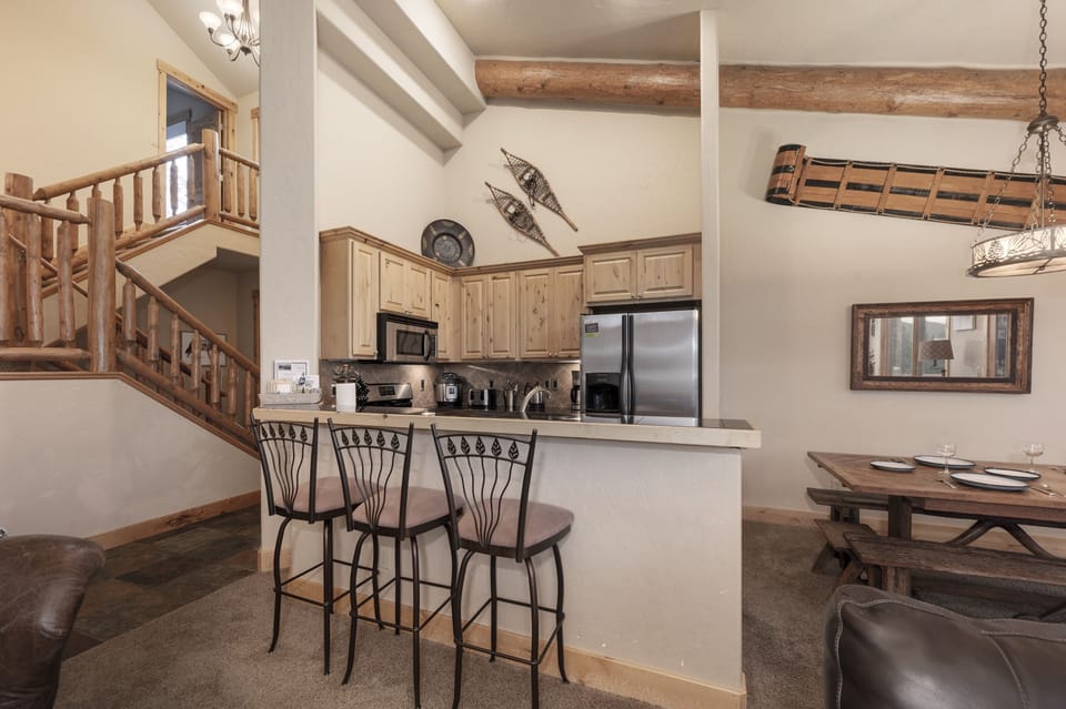 - Rustic kitchen with wood cabinetry and stainless steel appliances   - Breakfast bar with seating for quick meals or chats   - Perfect balance of modern convenience and mountain charm
