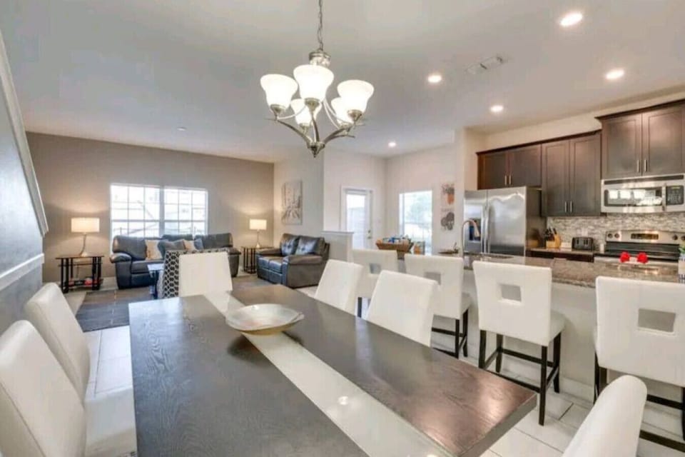 This elegant vacation home features an open-plan living area with ample seating and an stylish dining area, perfect for entertaining!