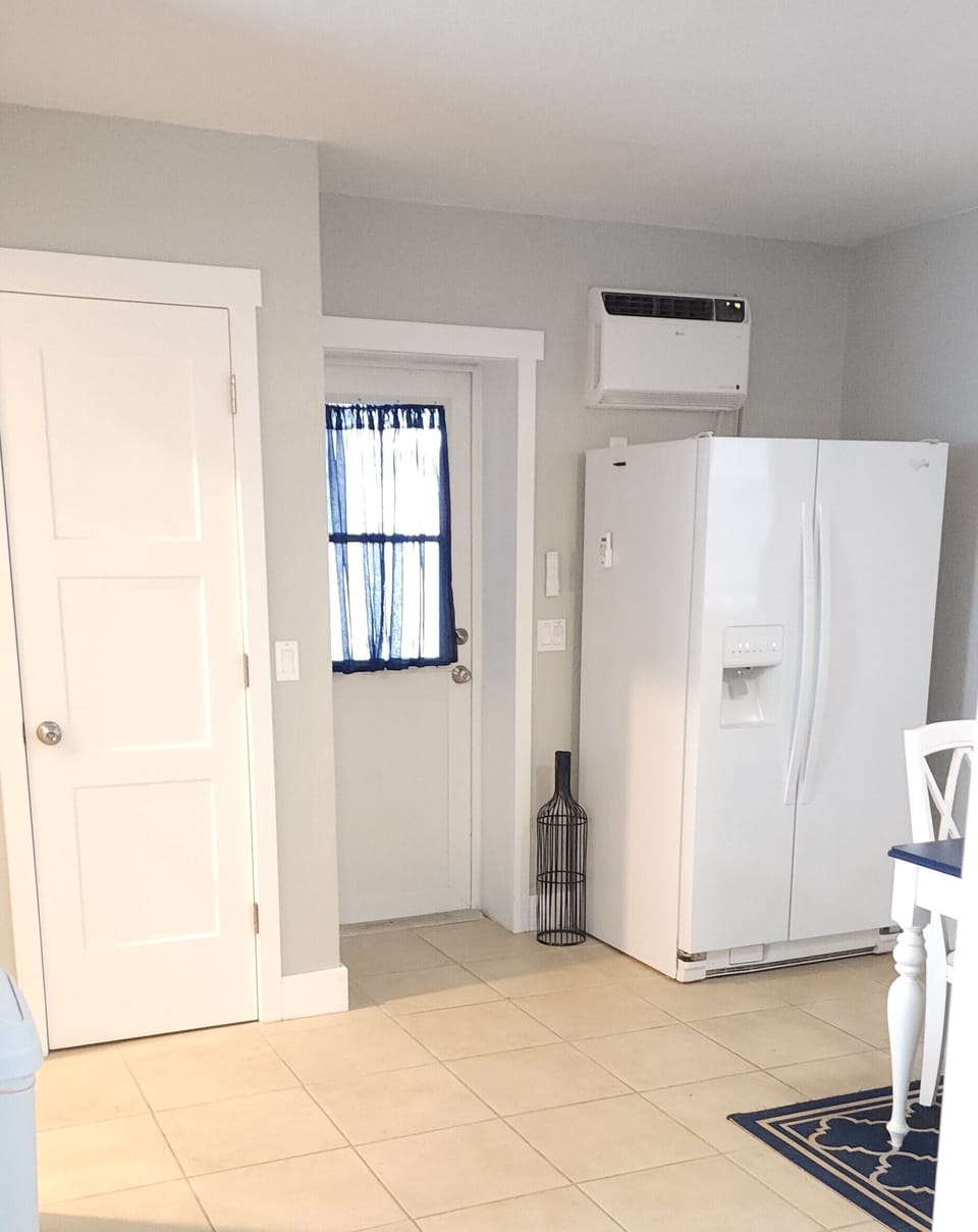 Fridge located next to entry door