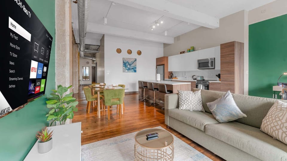 Living Room: Bright and airy space perfect for relaxation, with inviting decor and a large TV!