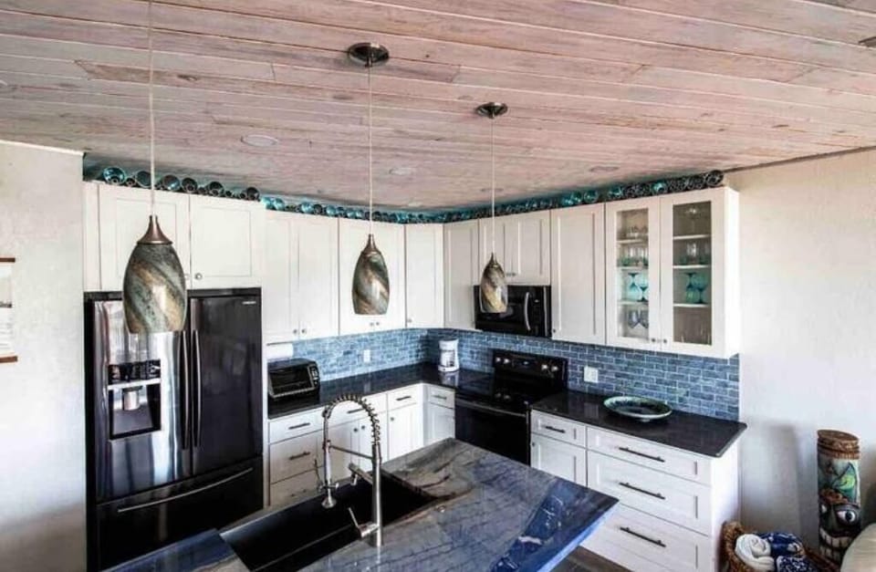 Completely modern and updated kitchen with Samsung appliances and aluminum art. 
