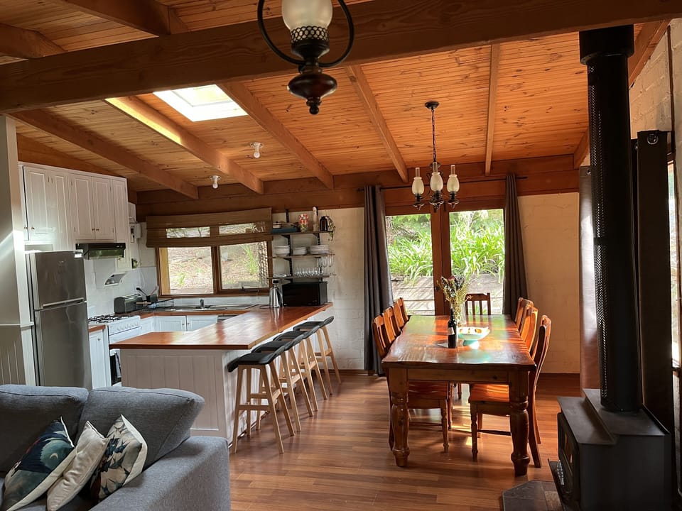Open living, kitchen & dining with wood heating