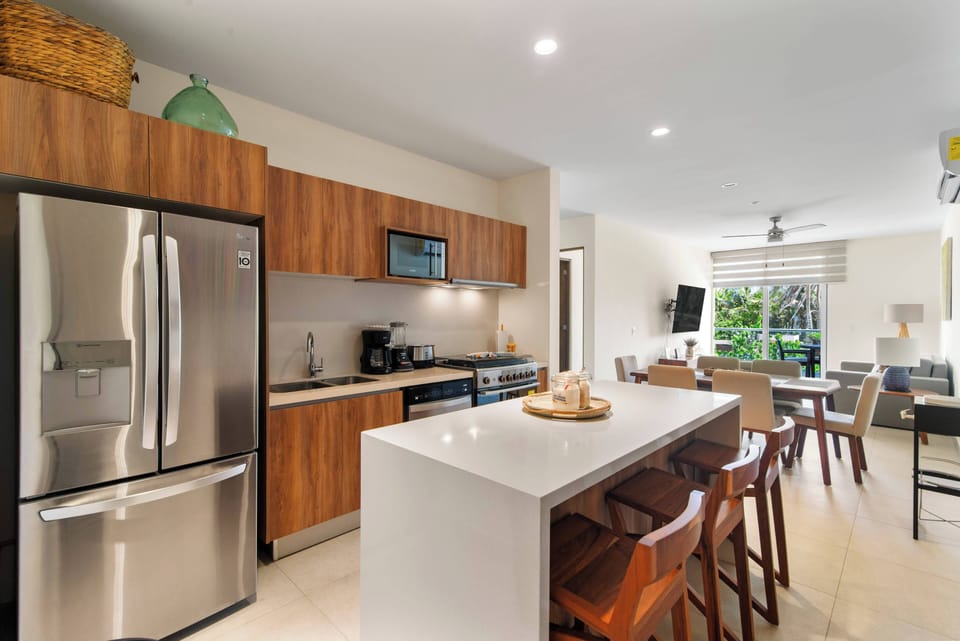 Enjoy our kitchen: stylish island, three stools—where cooking meets comfort, every meal savored.