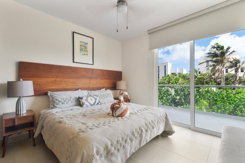 Unwind in a king bed with soft pillows as ocean breezes create a dreamy escape.