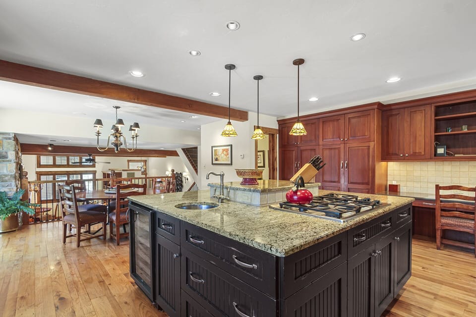 View of vegetable sink, gas range, and wine refrigerator
