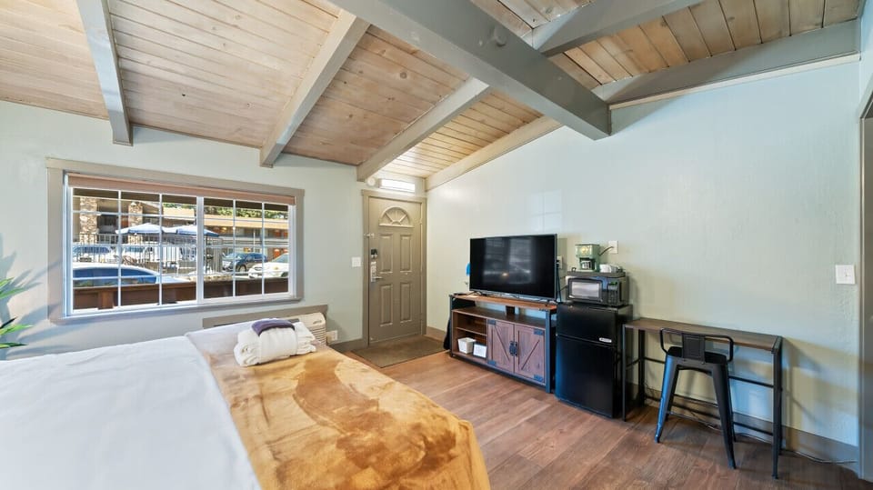 bedroom with TV and mini fridge