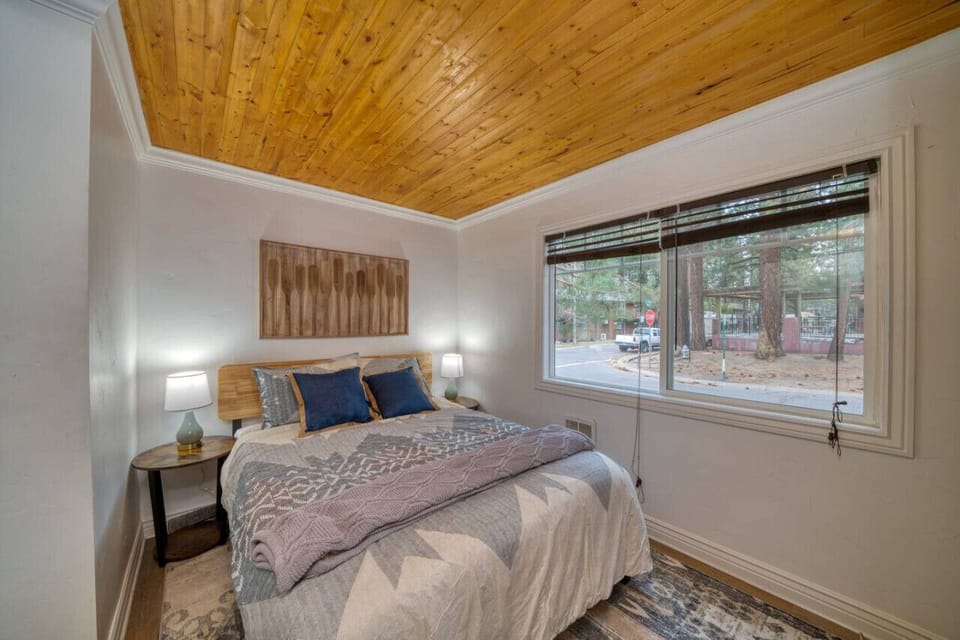 Cozy bedroom with queen-sized memory foam mattress and smart TV.