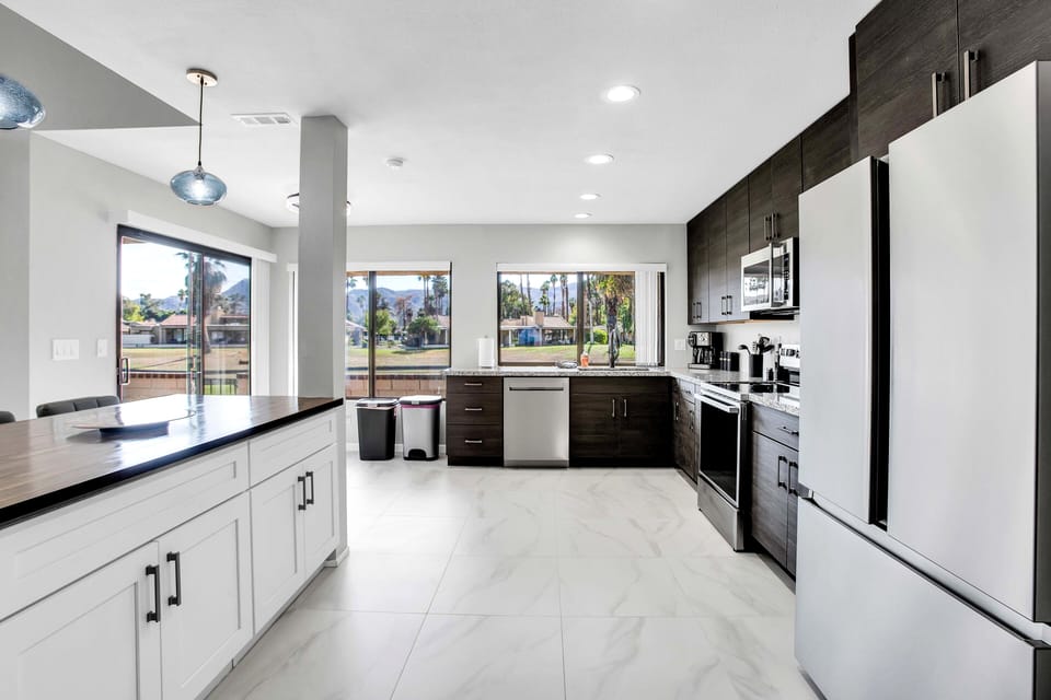 Bright modern kitchen with stainless appliances and scenic outdoor views