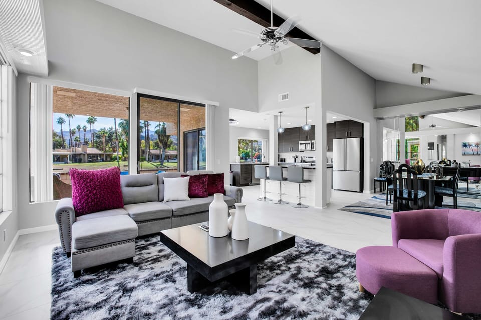 Spacious living area with patio access, open kitchen, and dining space