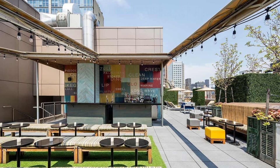 Unwind under string lights on the sunny rooftop terrace.