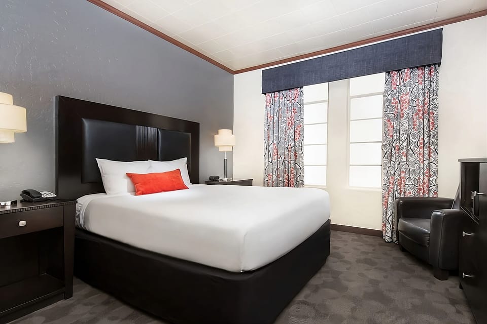 Wake up refreshed in a sunlit room with crisp bedding