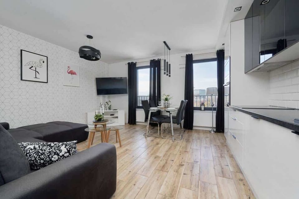 The elegant living room featuring a double sofa bed, perfect for relaxing or sleeping.