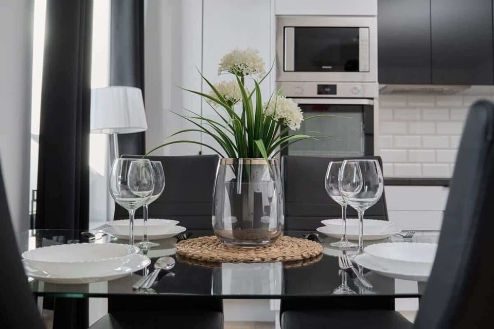 The living area features a sleek coffee table and a flat-screen television.